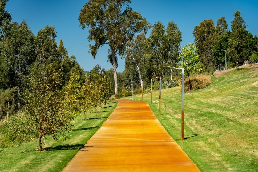 A yellow path leading to a grassy area, perfect for local tourism in Queensland.