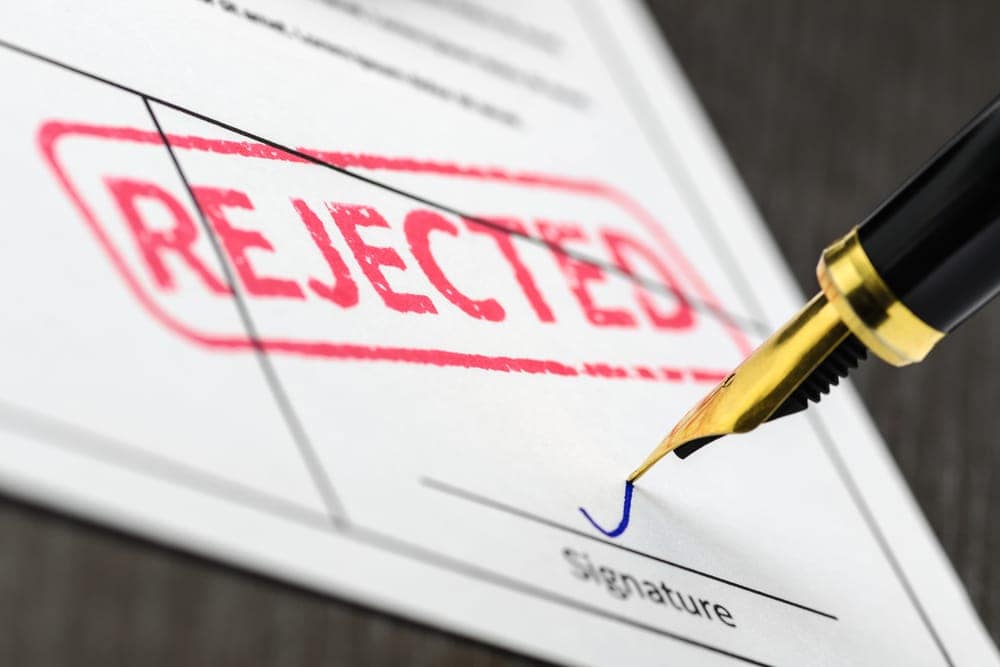 A pen with the word rejected written on it.