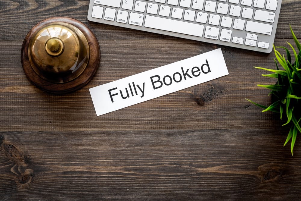 Fully booked sign on a wooden RV Park desk in North Carolina.
