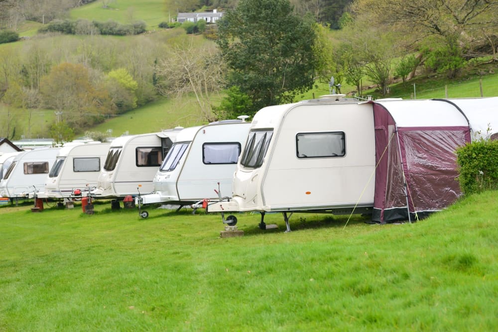 A group of rvs parked in a field.