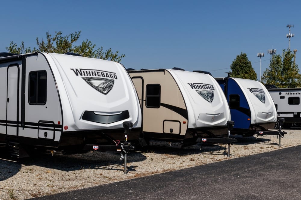 A group of Winnebago parked in a lot.