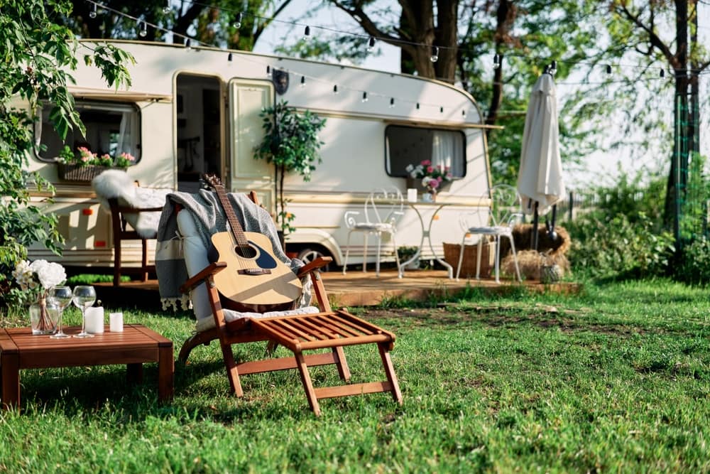 A camper trailer with chairs in the grass at Lazydays, owned by Robert Devincenzi, the Lead Independent Director.