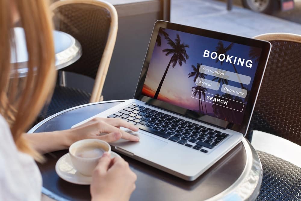 A woman joins ARVC's Integrated Partnership Program, using a laptop with the word booking on it.