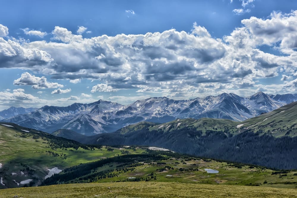 A view of a mountain range with clouds in the sky.