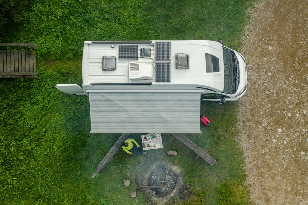 An aerial view of a camper with a fire pit showcased at METSTRADE 2021.