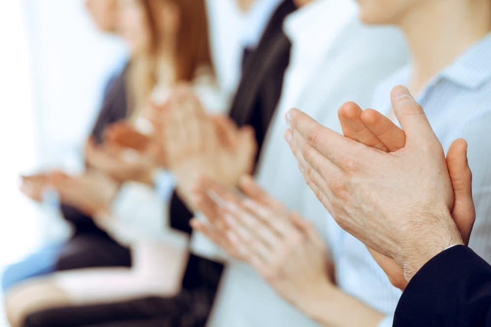 A group of people clapping hands.