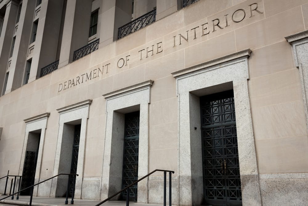 The Interior Department building is shown, featuring Winnie Stachelberg, Senior Advisor.