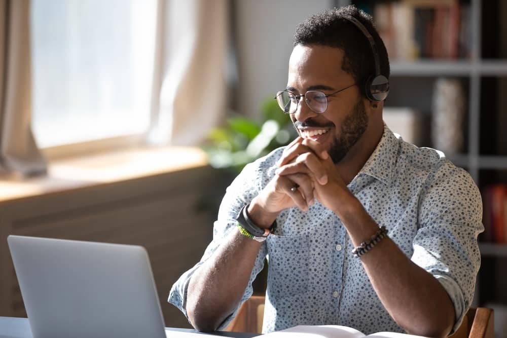A man wearing headphones is working on a laptop during a Vendor Training for the RVDA Convention/Expo.