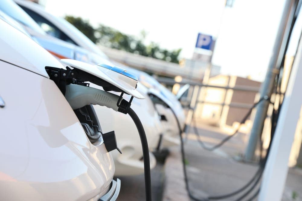 An electric vehicle is being charged at a charging station in Australia.