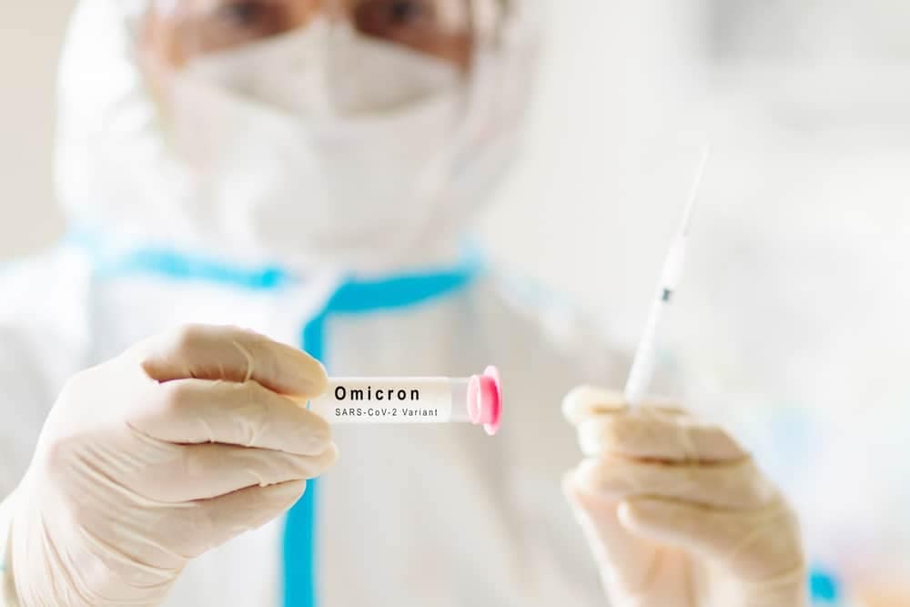 A doctor administering a syringe of coronavirus vaccine to travelers under stricter COVID testing regulations mandated by the U.S. Gov't.