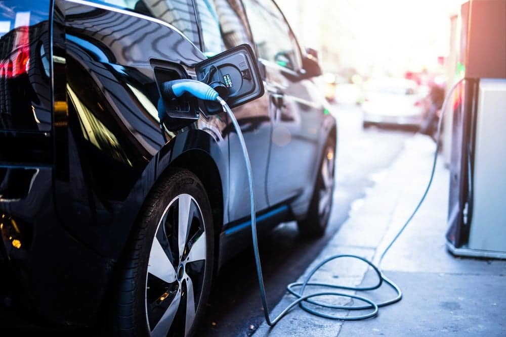 An EV is plugged into an electric charger.