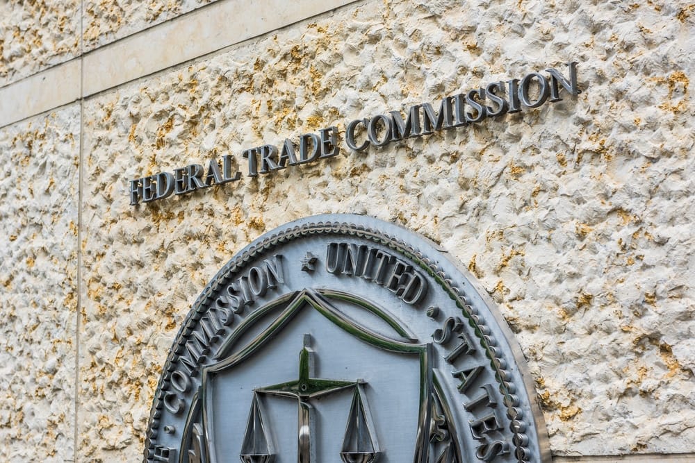 A building prominently displays the FTC logo, representing its authority over big companies while also addressing potential supply chain disruptions.