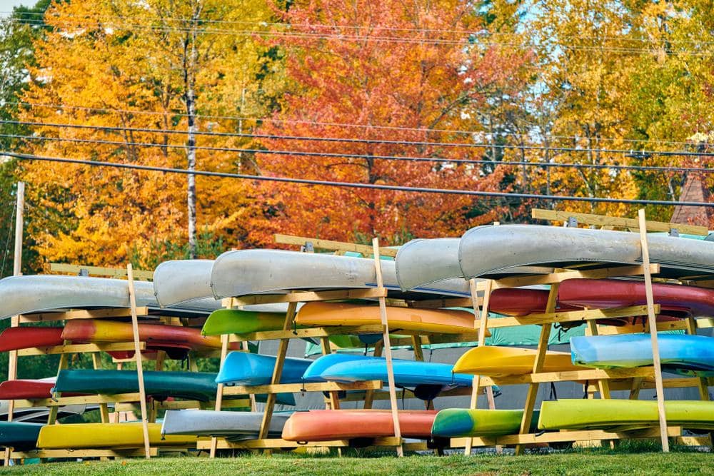 Due to the pandemic and staffing shortages, many canoes are lined up in front of trees in Maine's tourism hotspot.