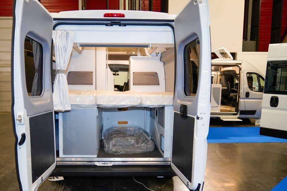 The interior of a camper van with the door open.