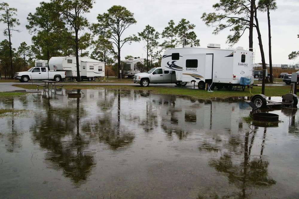 A group of rv's parked in a flooded campground at the National Seashore.