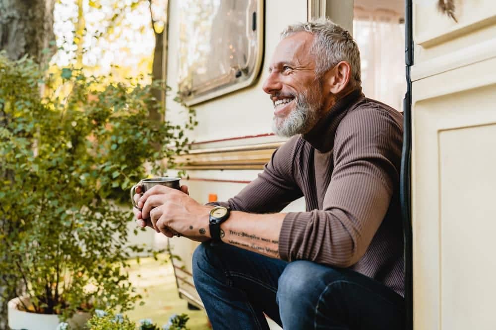 MARVAC publishes the 2022 Edition featuring a man sitting outside of a camper with a cup of coffee.