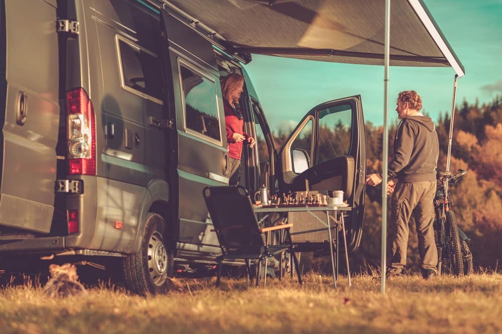 A couple posing next to an RV at the 40th RV Show in Idaho.