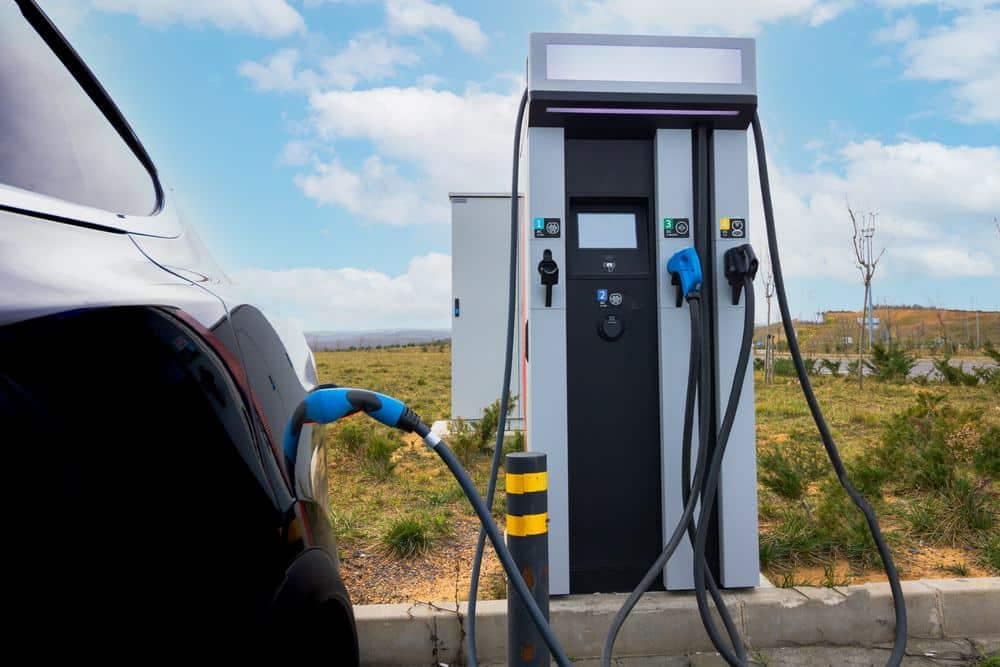 A car is plugged into an electric charging station.