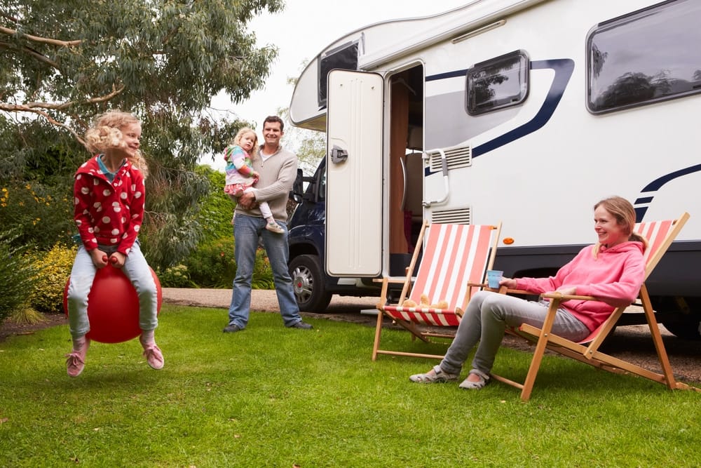 A family is playing with a ball in front of an FRVCA.