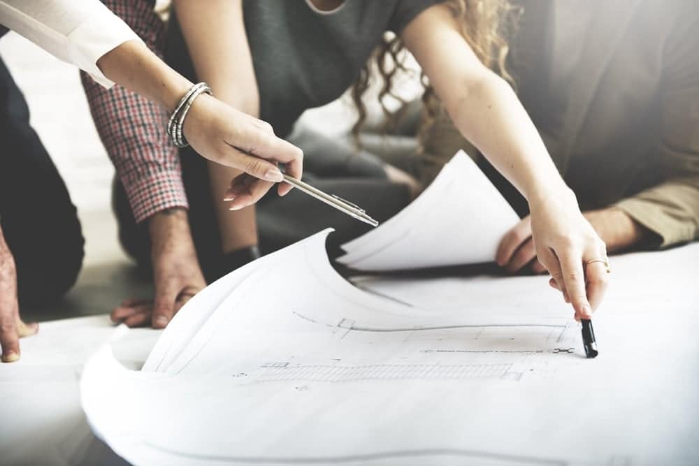A group of people working on blueprints.