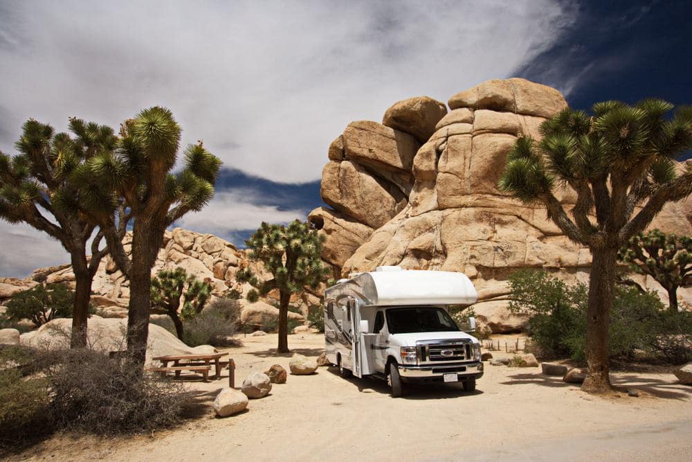 A white rv parked in joshua tree national park.