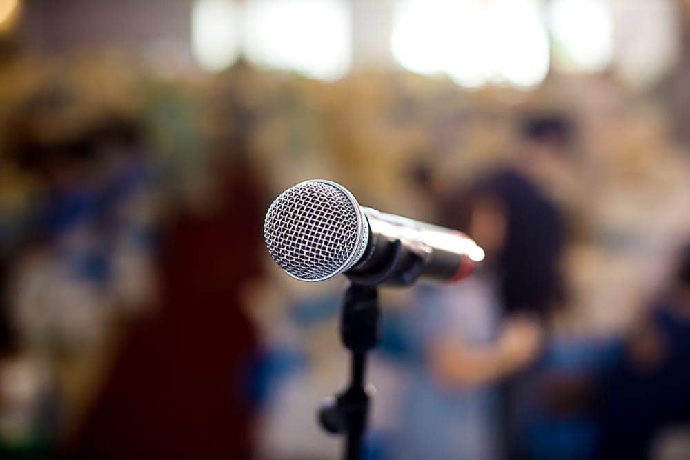 A controversial public hearing on the Preston RV Park Proposal, with a microphone in front of a crowd of people.
