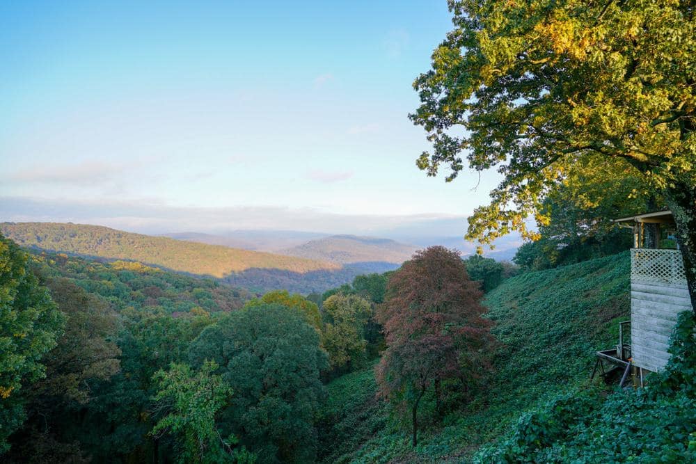 In Arkansas, a house sits on top of a hill overlooking a valley, providing the perfect setting for recreation grants activities.