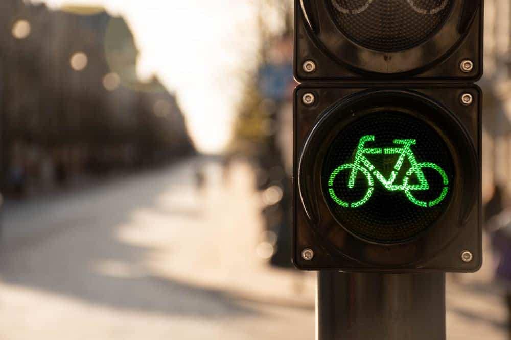 A traffic light in Fairmont with a bicycle on it.