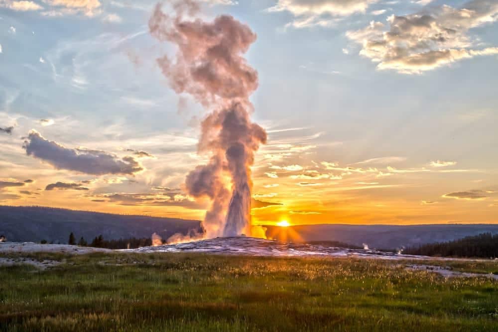 Upgrade, Yellowstone: Geyser at sunset in upgraded Yellowstone national park.