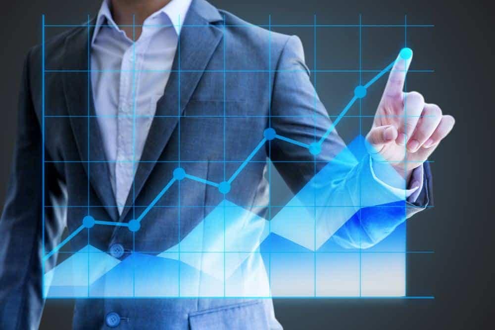 A businessman is pointing at a graph.
