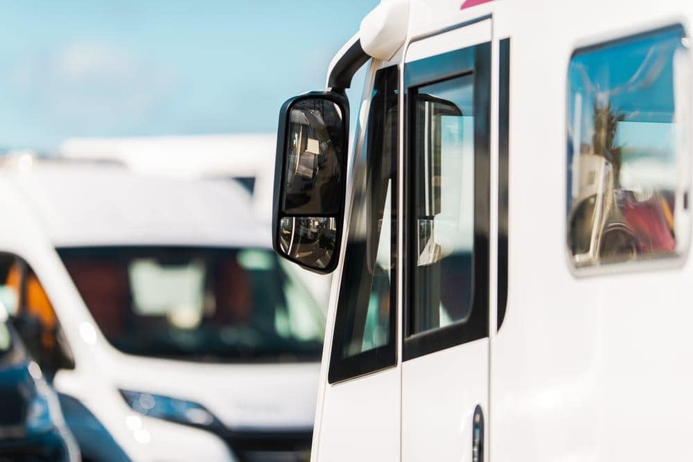 A group of rvs parked in a parking lot.