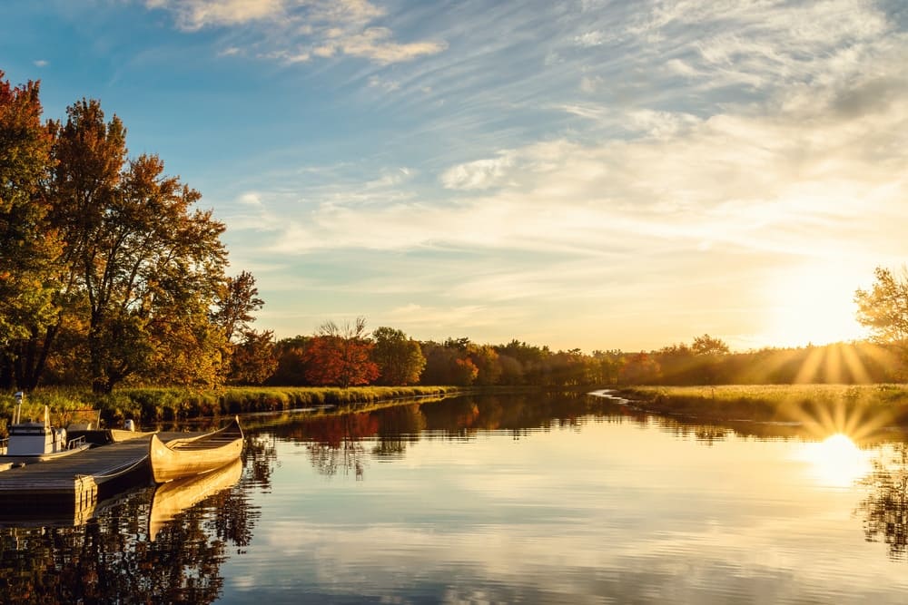 Visitors enjoy a boat docked in a river at one of the beautiful parks in Nova Scotia.