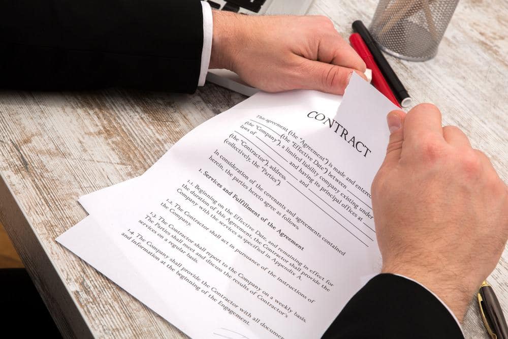 A contractor signing a construction contract on a desk at River Ranch County Park.