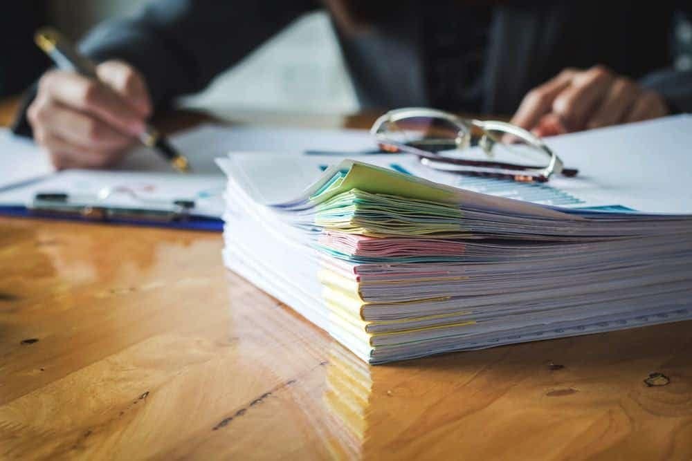 A stack of Tremont Campground papers on a table.