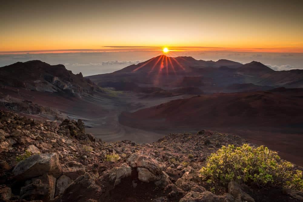 The sun rises over a mountain in Hawaii at Kīpahulu Campground.