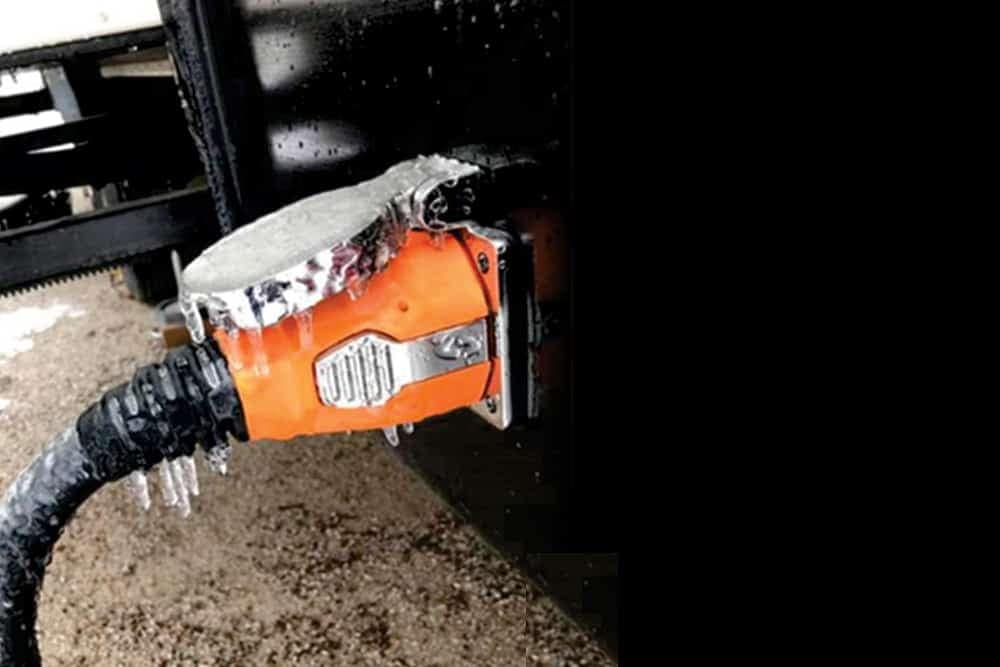 A truck with ice-covered hose is connected to a Shore Power System via a SmartPlug and Cordset.