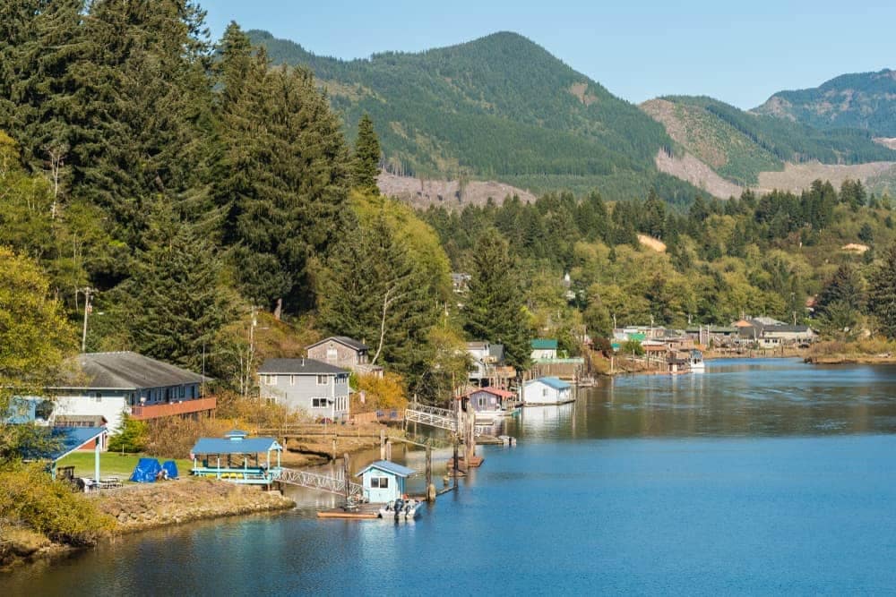 A river with houses on it and mountains in the background, providing access to North Twin Lake Day Use activities.