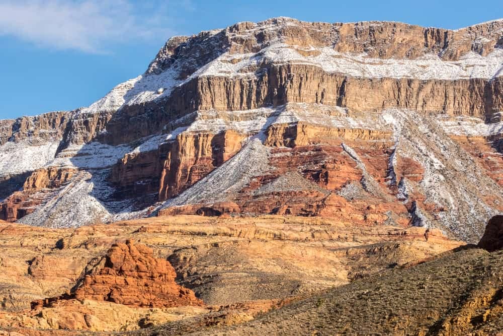 A popular view of the grand canyon with snow-capped cliffs.
