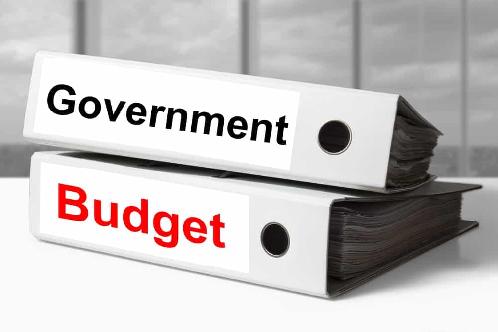 Two binders with the words government budget on them, including the keywords "Biden Administration" and "National Park Service.