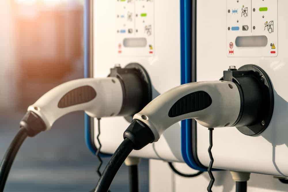 Two electric vehicles are plugged into a CA$5,000 British Columbia Rebate Program charging station.