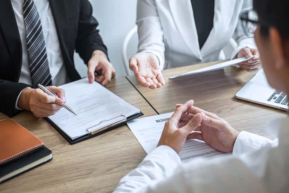 A group of people sitting at a table and discussing jobs in the U.S.