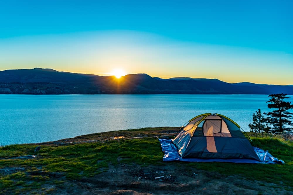 To kick off the camping season in Thompson-Okanagan, a tent is set up on top of a hill with stunning views overlooking a lake.