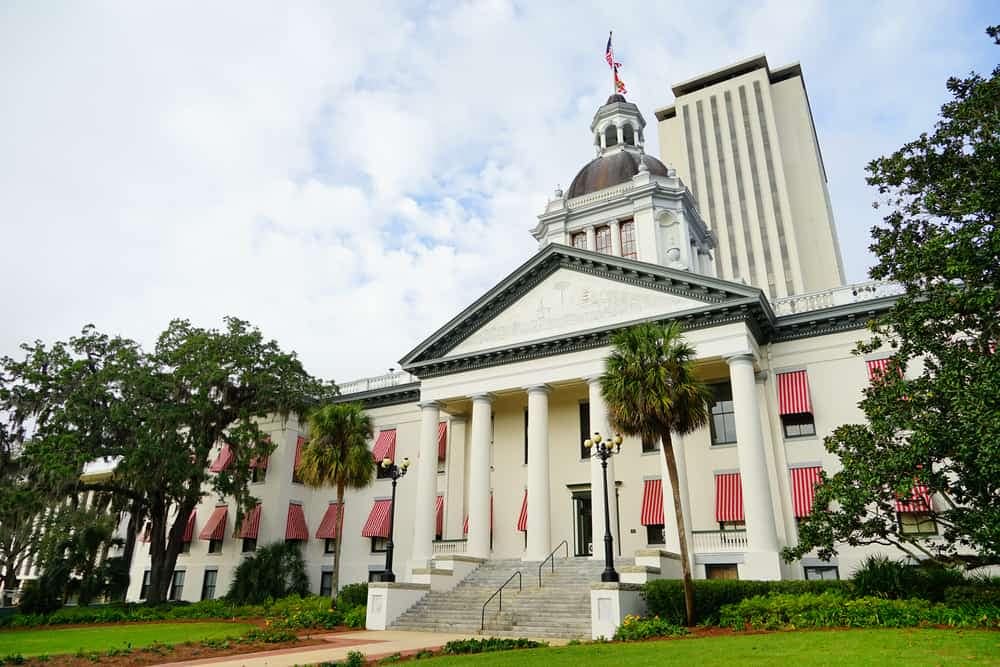 A white building with a clock tower in Florida.