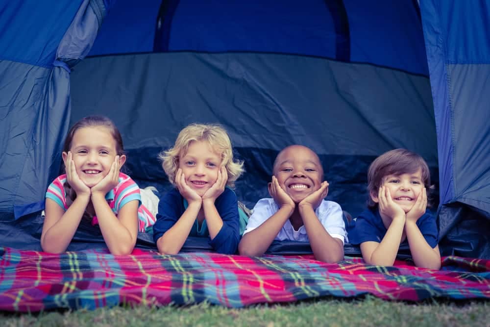 A group of children from the Camping Association, enjoying their time in a tent thanks to Manitoba Gov't Grants.