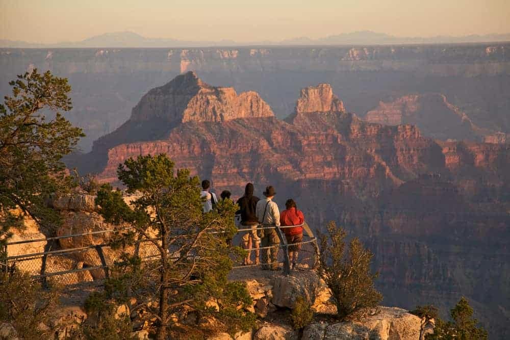 A group of people standing on a ledge overlooking the grand canyon in New Jersey State Parks.