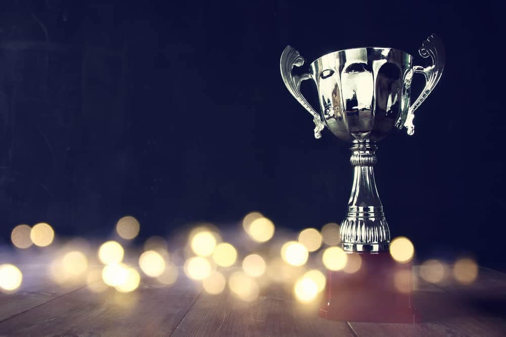 A silver trophy on top of a dark wooden table, representing the prestigious Business Recognition Award presented by Elkhart Chamber of Commerce to Nexus RV.