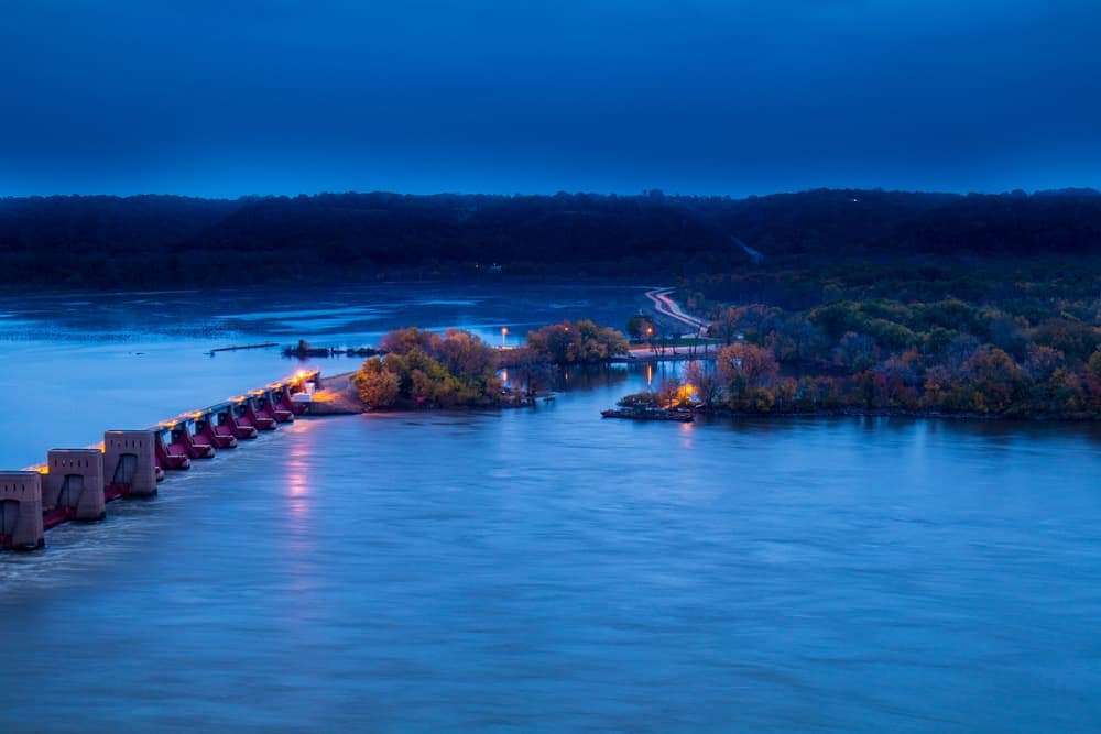 A bridge over a body of water in Dubuque City Parks at dusk, opening in the 2022 season.