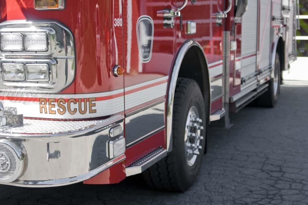 A red fire truck is parked in a Campground.