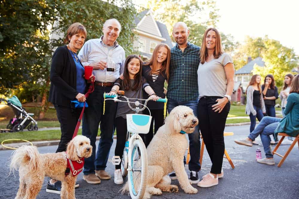 A family with a dog posing for a photo at Hyde Hall.