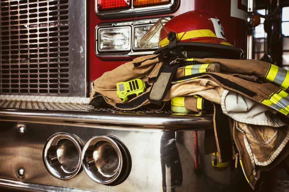Fire-Ravaged firefighter's gear is sitting on top of a fire truck.